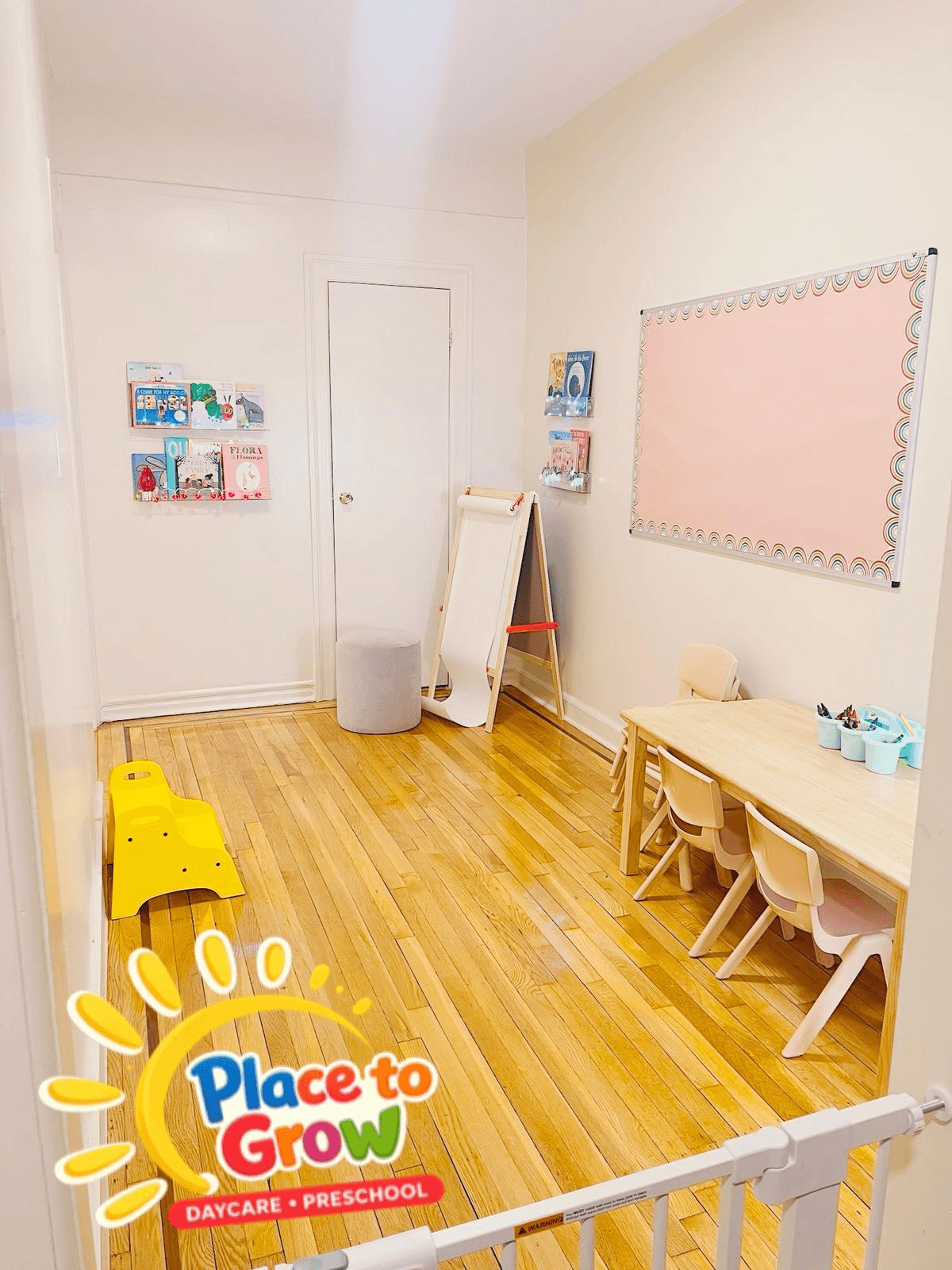 Place To Grow Bronx playroom with sun mural, wood floors and safe play stations